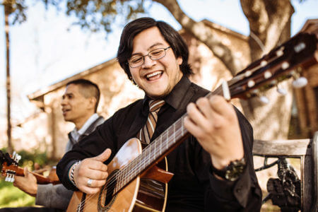 Trinidad Agosto plays the guitar