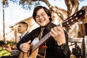 Marianists playing music in a grove at St. Mary's