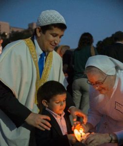 Participants light their candles during the IPP event at the Bell Tower