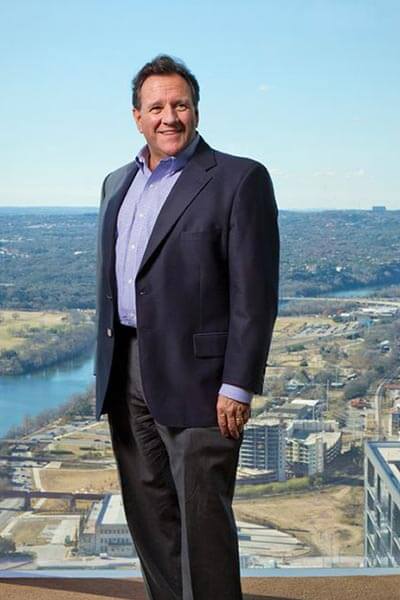 St. Mary's School of Law graduate Terry Mitchell poses in a building showing off the Austin view from downtown.