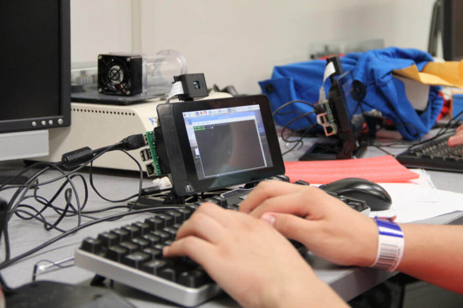 Physics camper typing on a Raspberry Pi