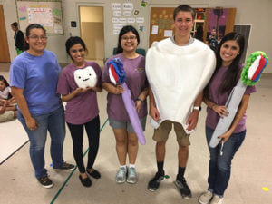 Pre-dental senior Millie Garcia stands center with students.