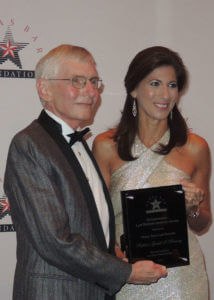 Geary Reamey accepts award.