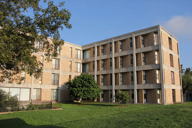 Side view of Treadaway Hall, a four-story brick building